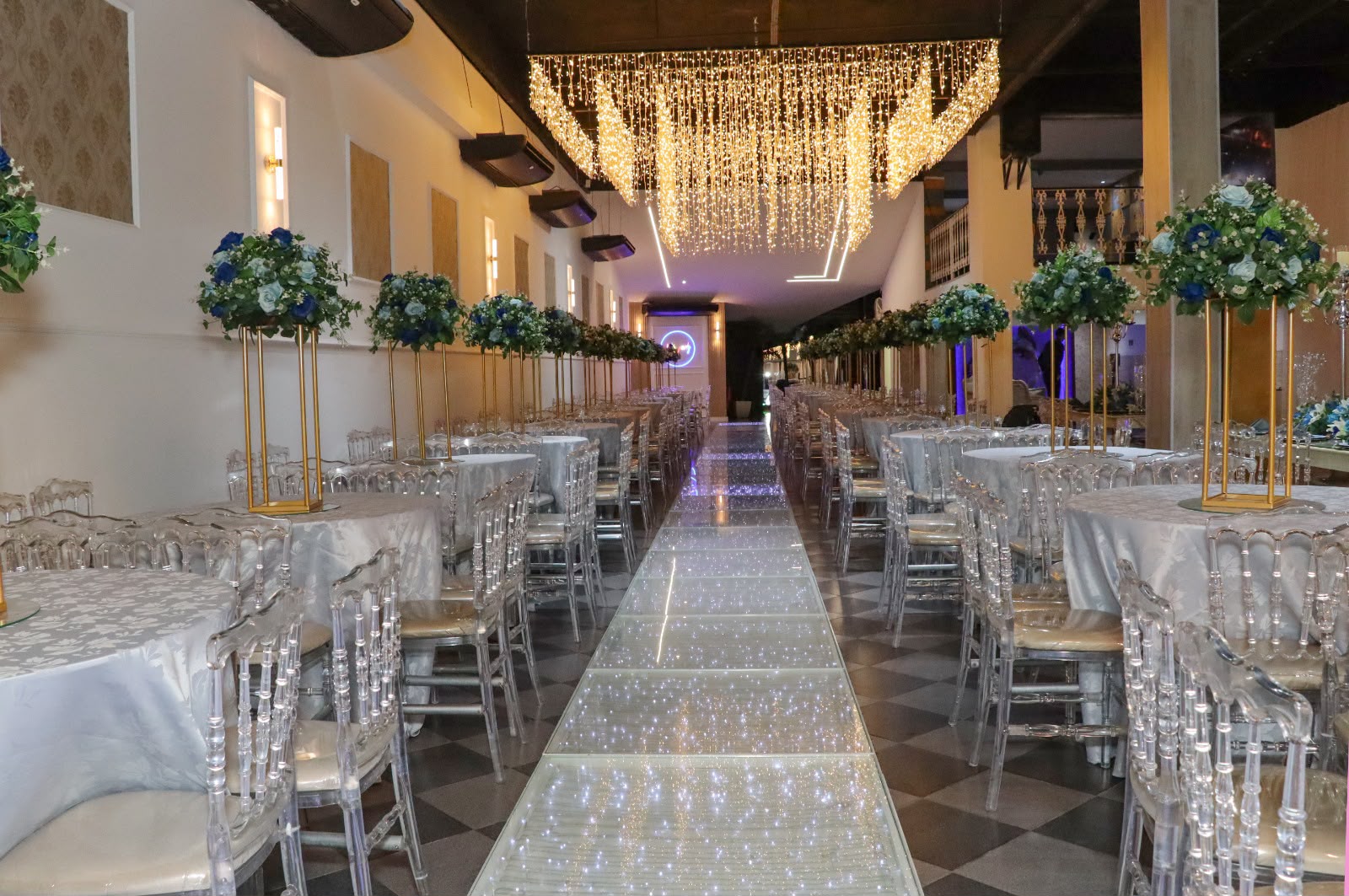 Salão com lustre de cristal e passarela iluminada